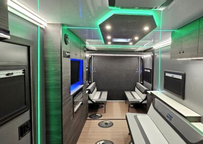 Interior view of CORE RV toy hauler showing the living space, entertainment cabinet and seating options